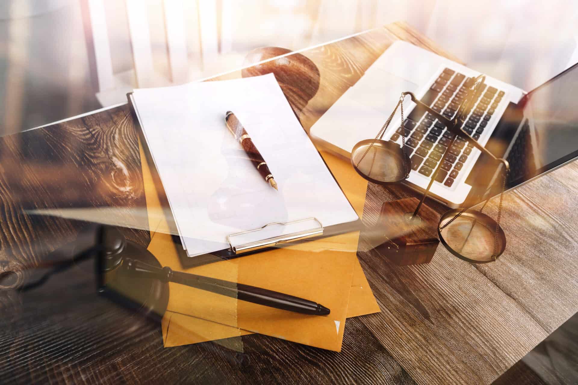 legal workspace with a gavel, scales, and laptop on a wooden desk - What is Preventative Law?