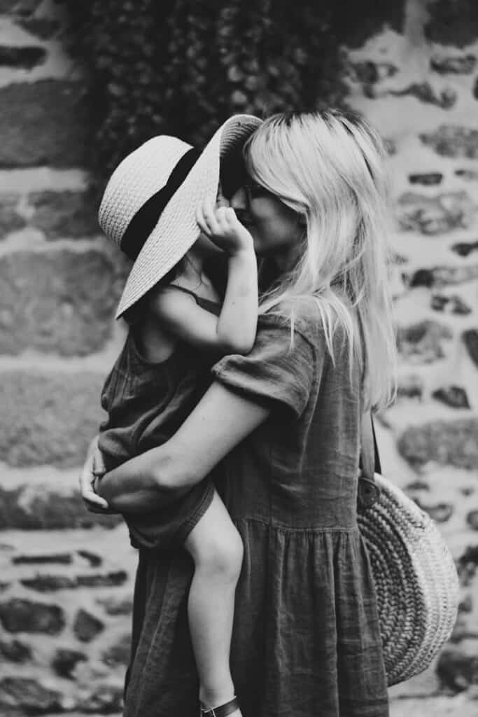 Black and white photo of a mother holding her child, symbolizing family care and protection in estate planning